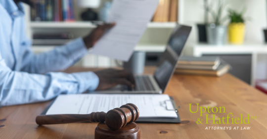 Image of HR executive reviewing documents with a gavel in the foreground