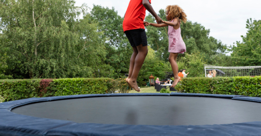 Dad and child on trampoline
