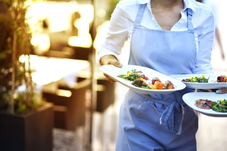 Waitress holding three plates