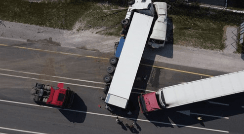 two wrecked semi trucks blocking a highway